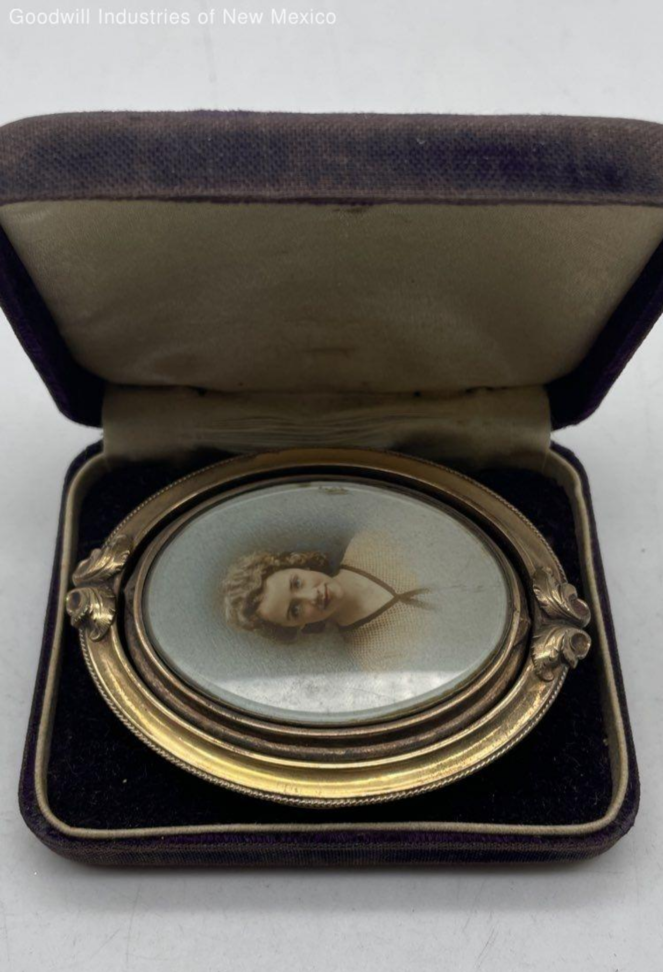 Gold brooch with woman's photo