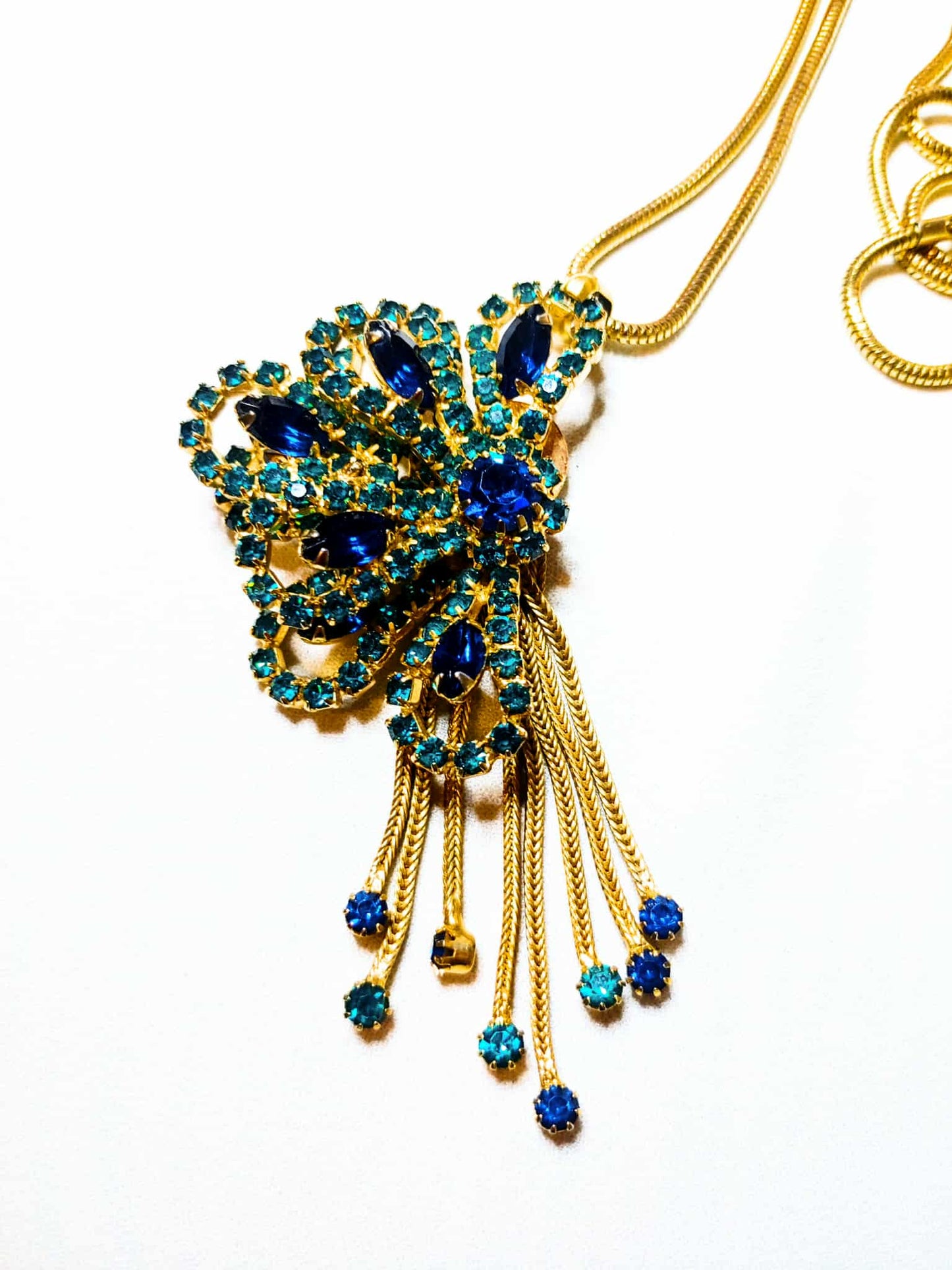 Gold and blue necklace on a white background