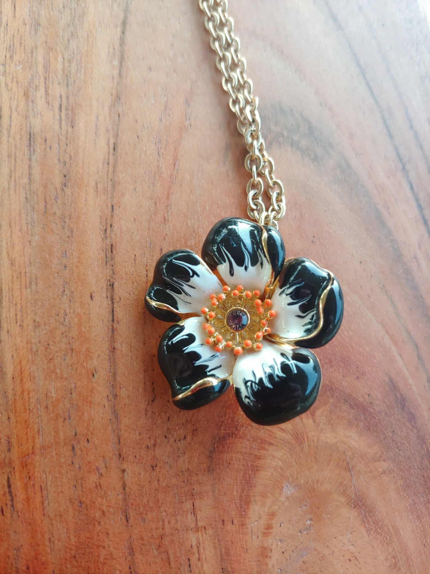 Floral pendant necklace on a wooden surface