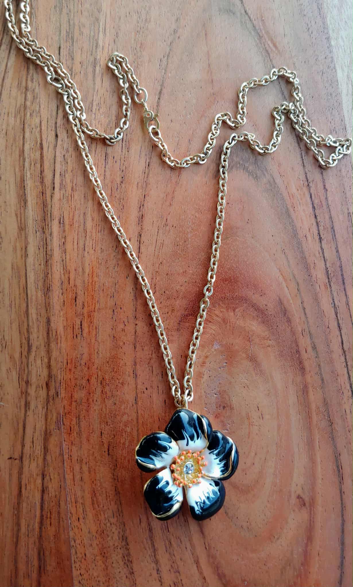 Floral pendant necklace on a wooden surface