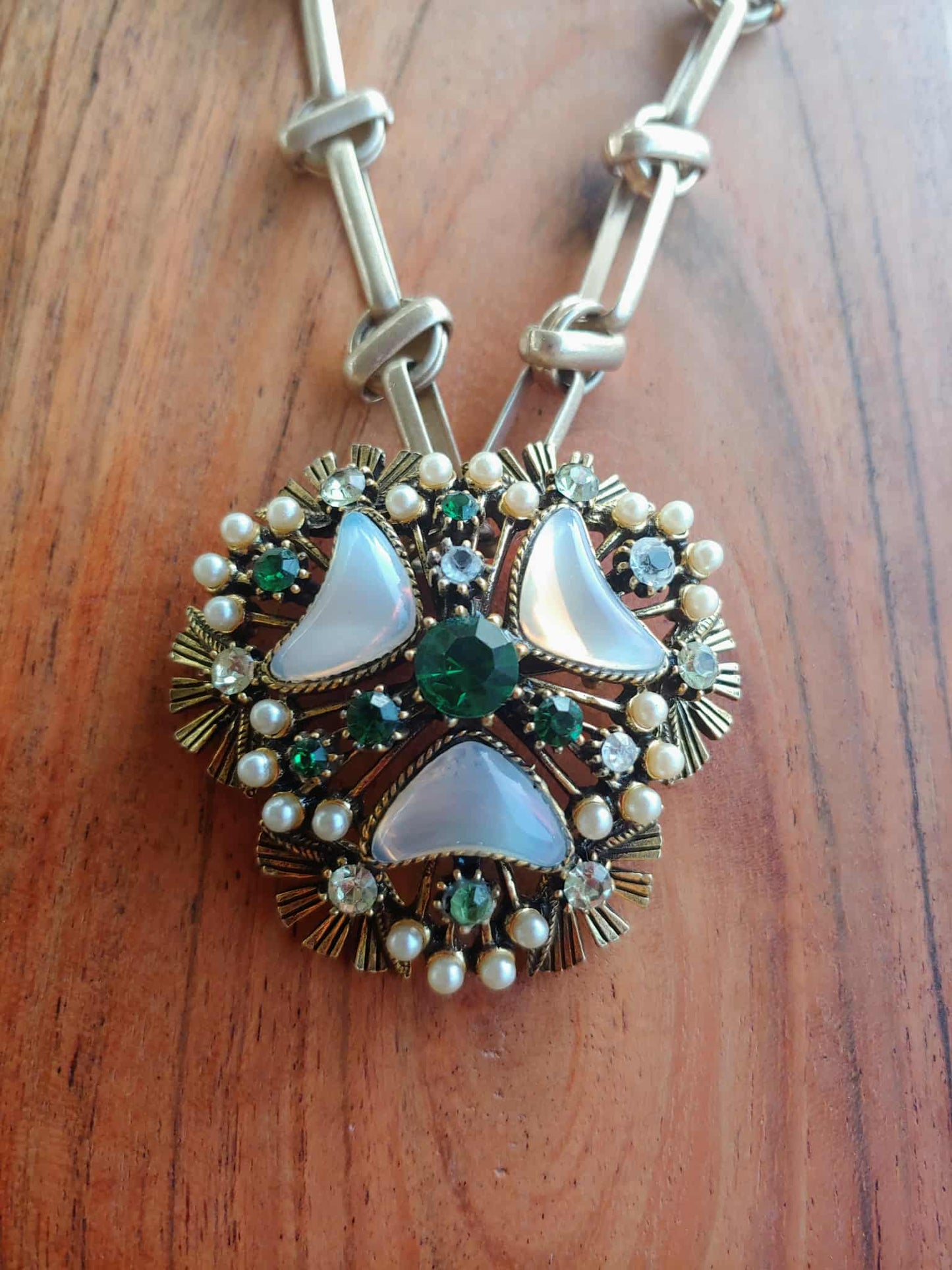 Decorative necklace with pendant on a wooden surface