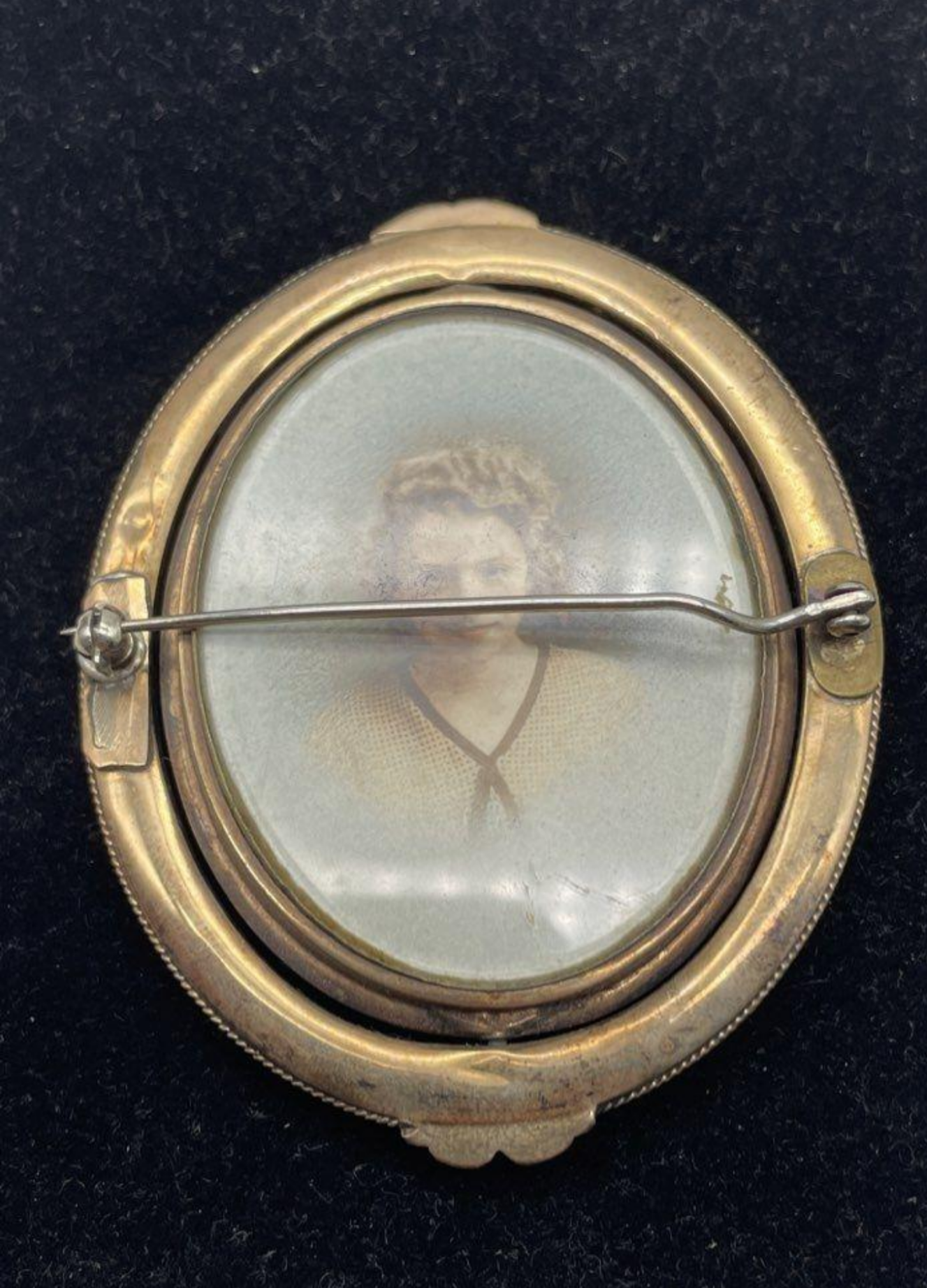 Back of brooch with portrait of girl