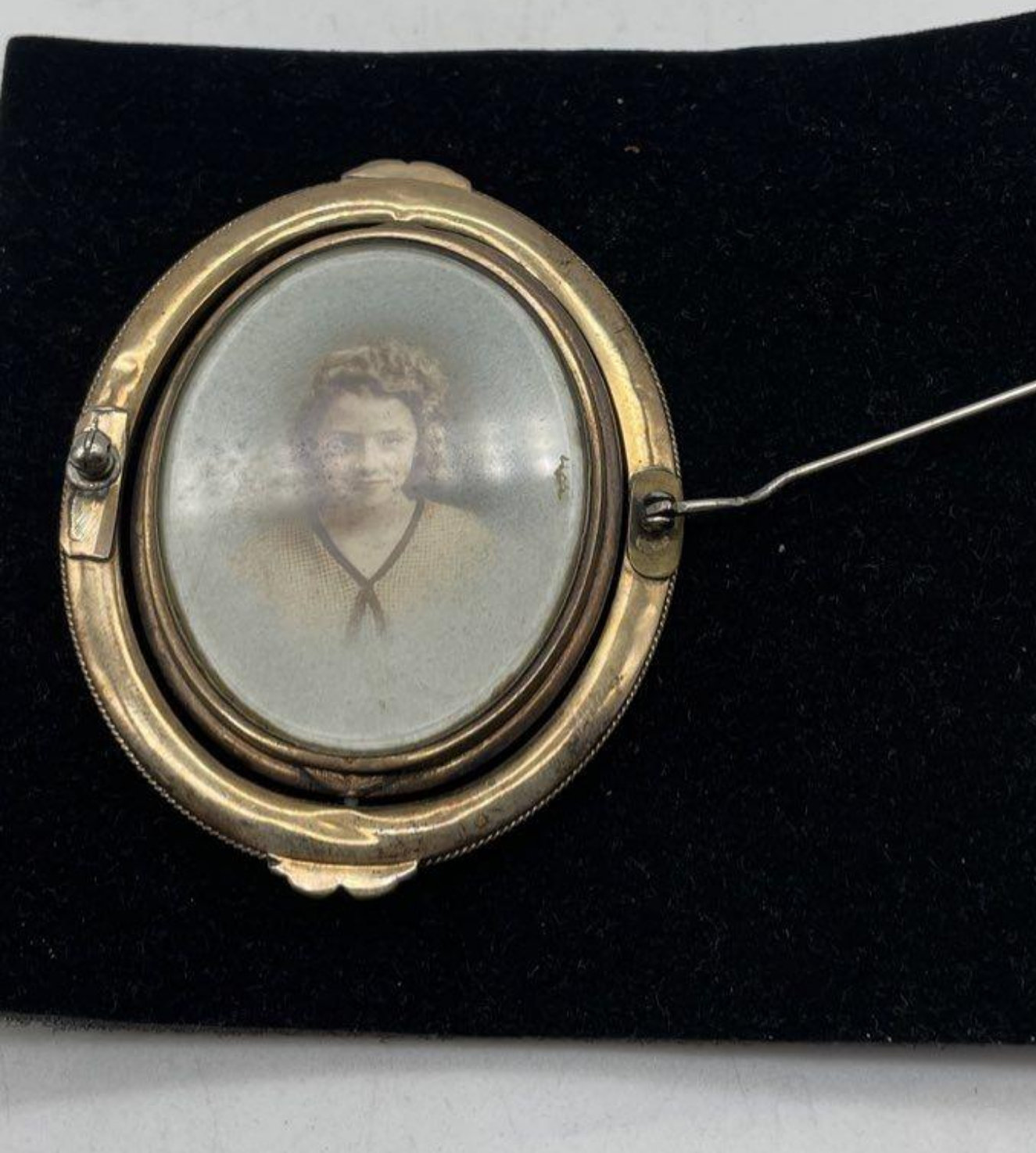 Gold brooch with woman's photo