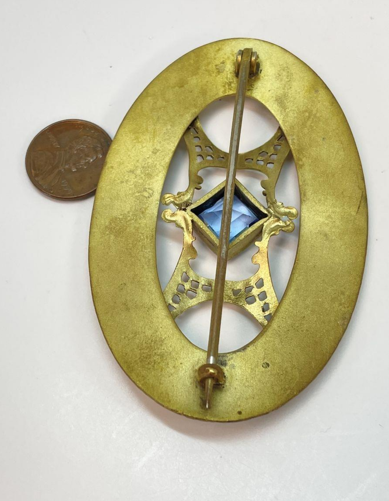 Back of brass brooch with c clasp