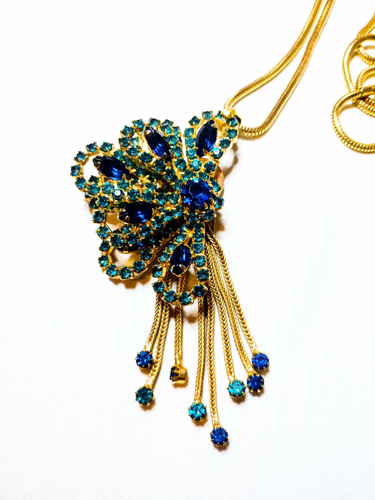 Gold and blue necklace on a white background