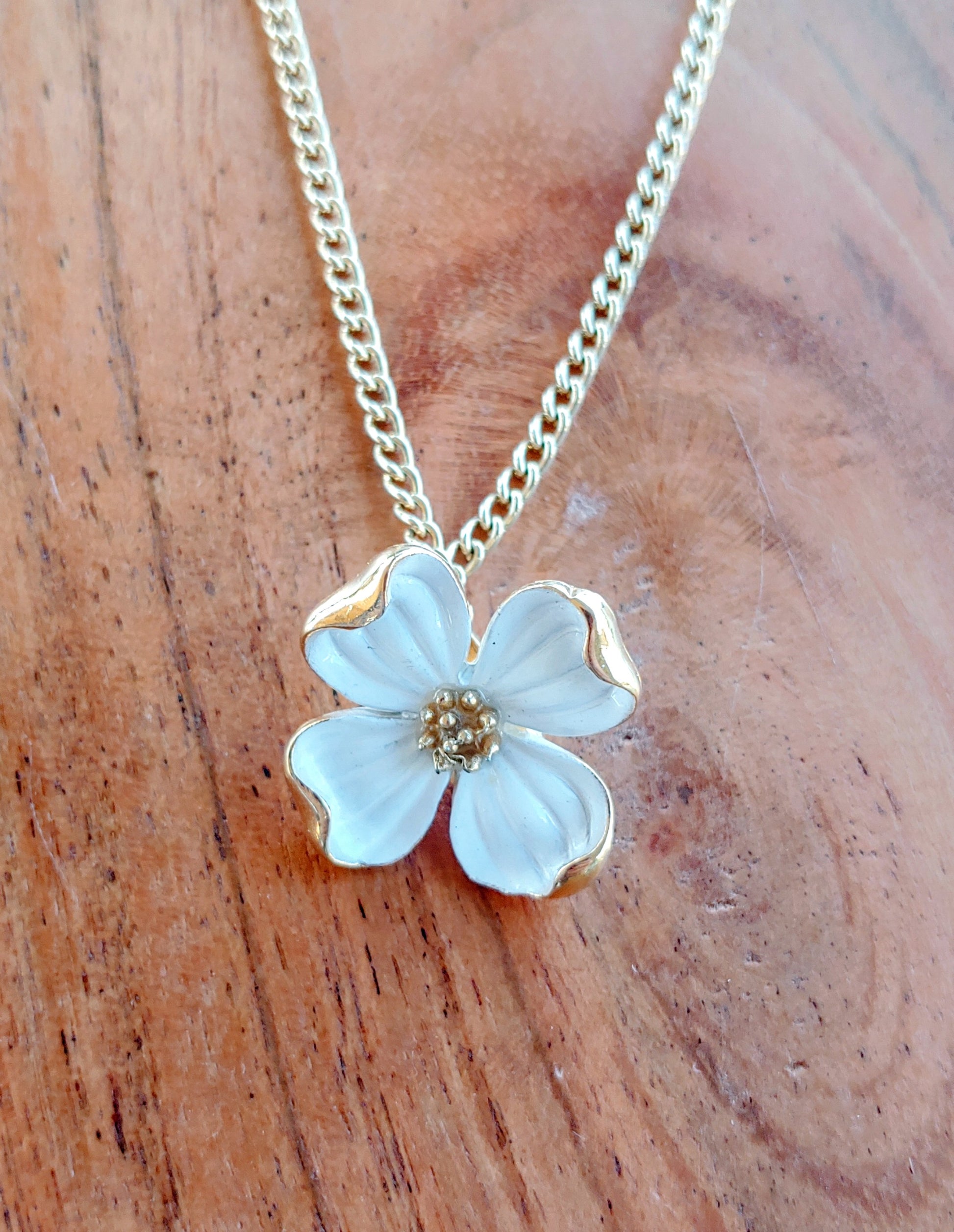 Floral pendant necklace on a wooden surface