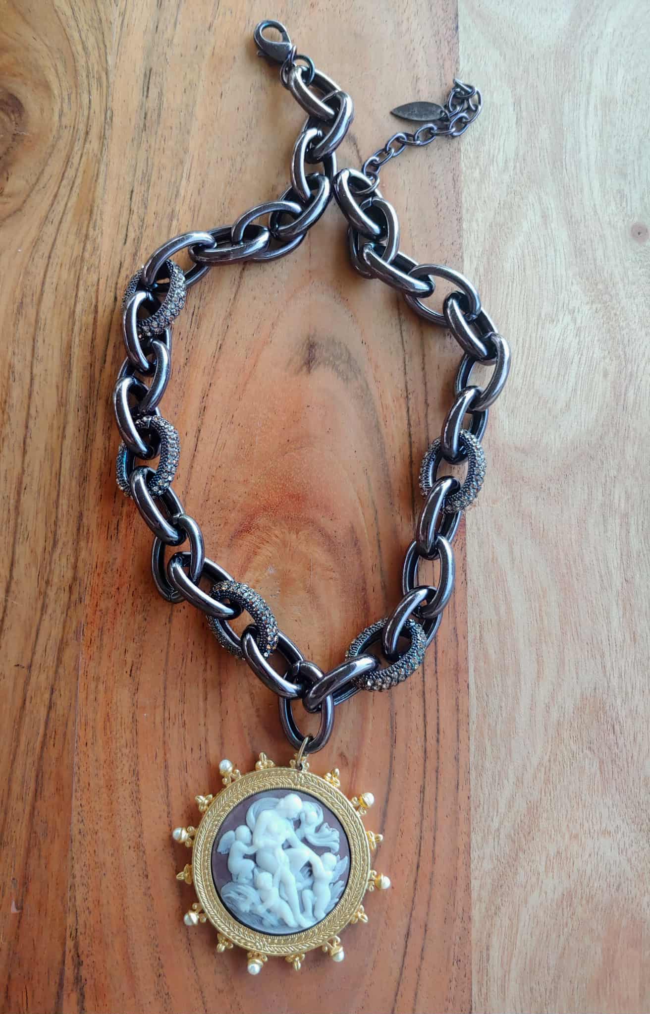 Chain necklace with a pendant on a wooden surface