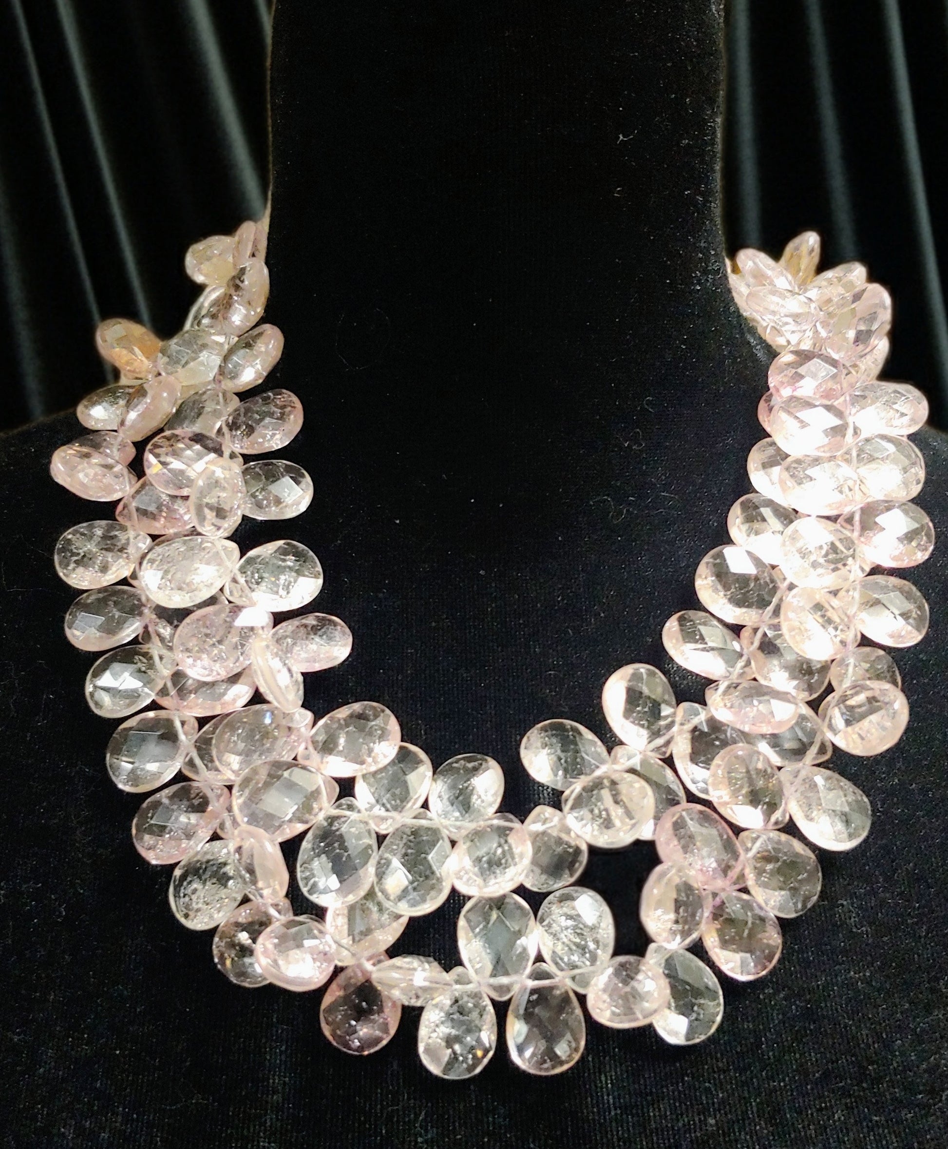 Pink quartz necklace on black background