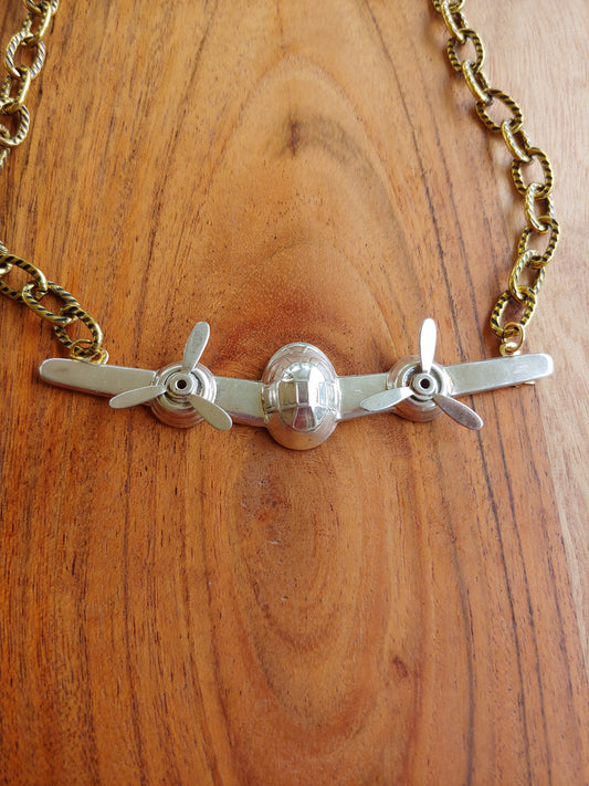 Airplane pendant on gold necklace