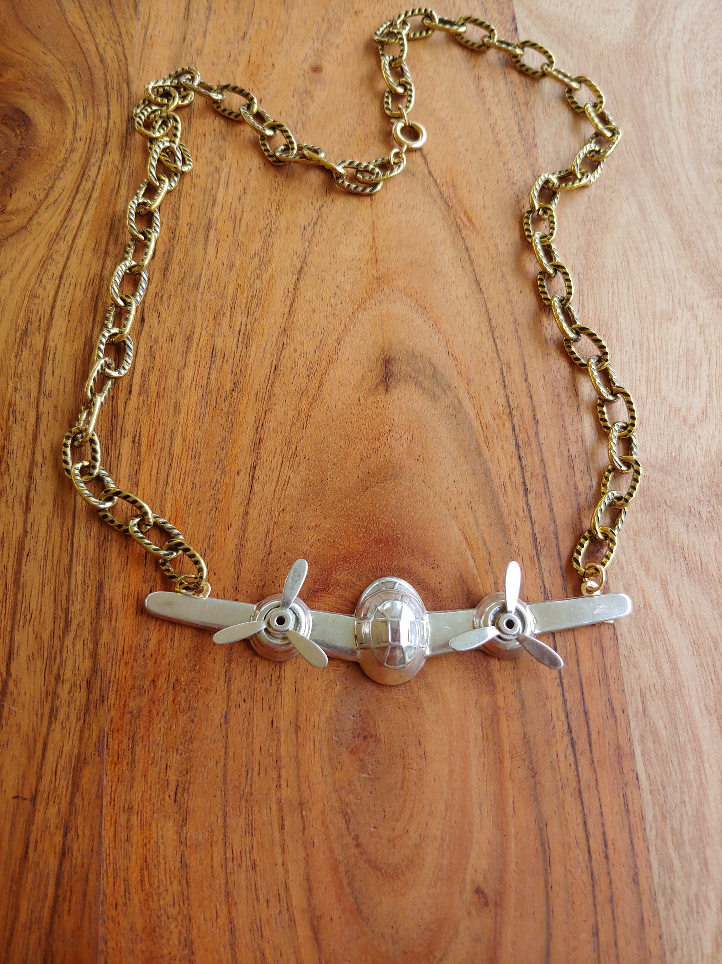 Airplane pendant on gold necklace