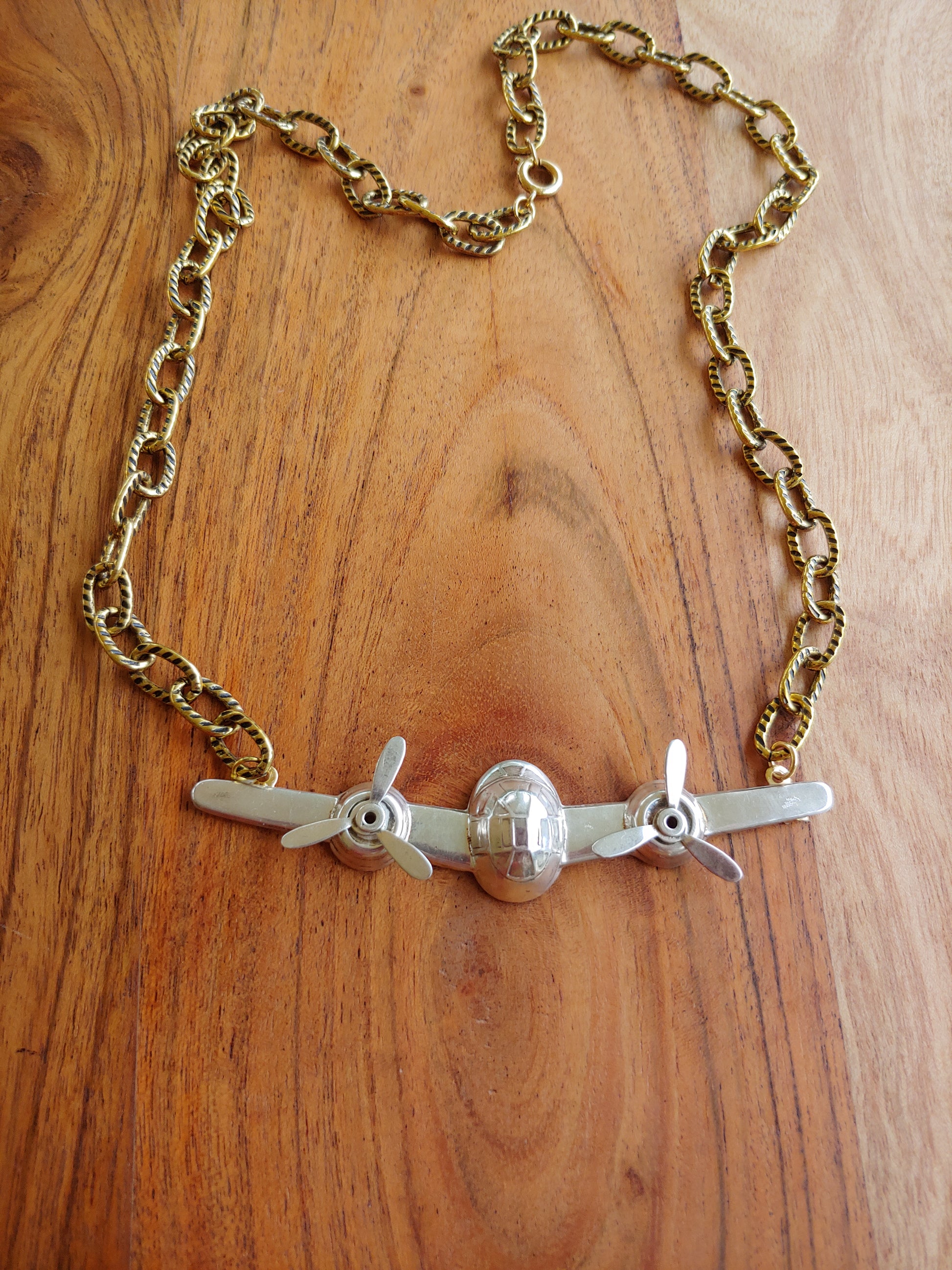 Airplane pendant on gold necklace