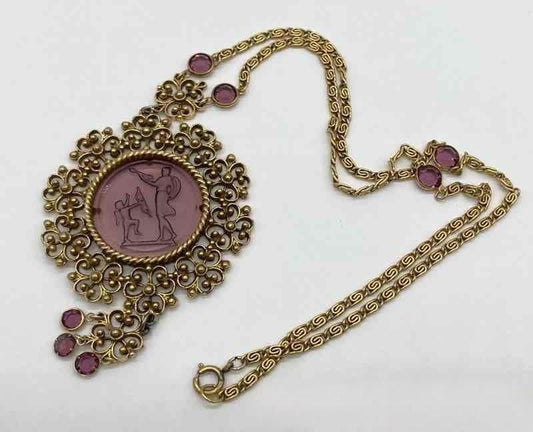 Purple glass pendant in gold necklace