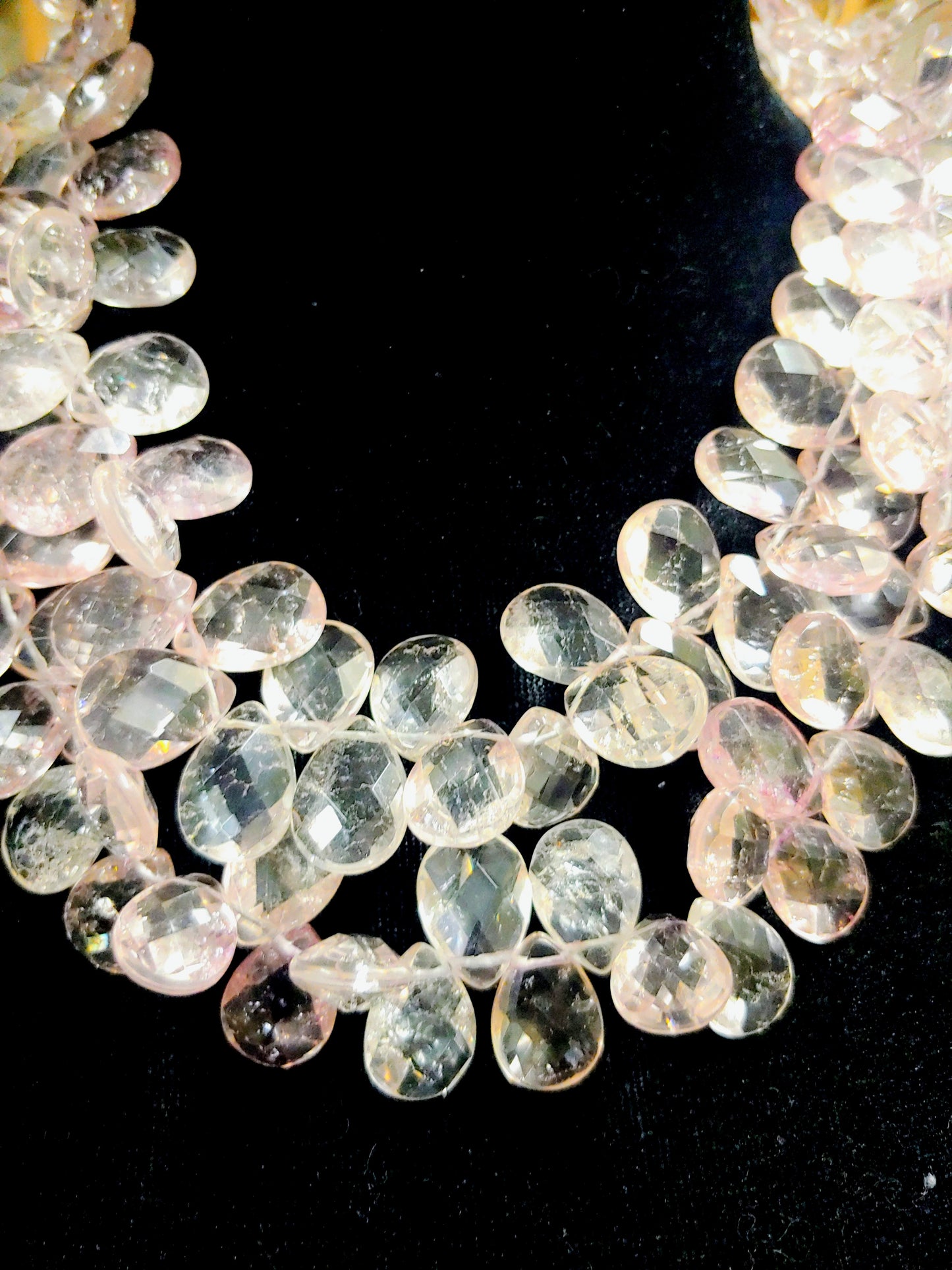 Pink quartz necklace on black background